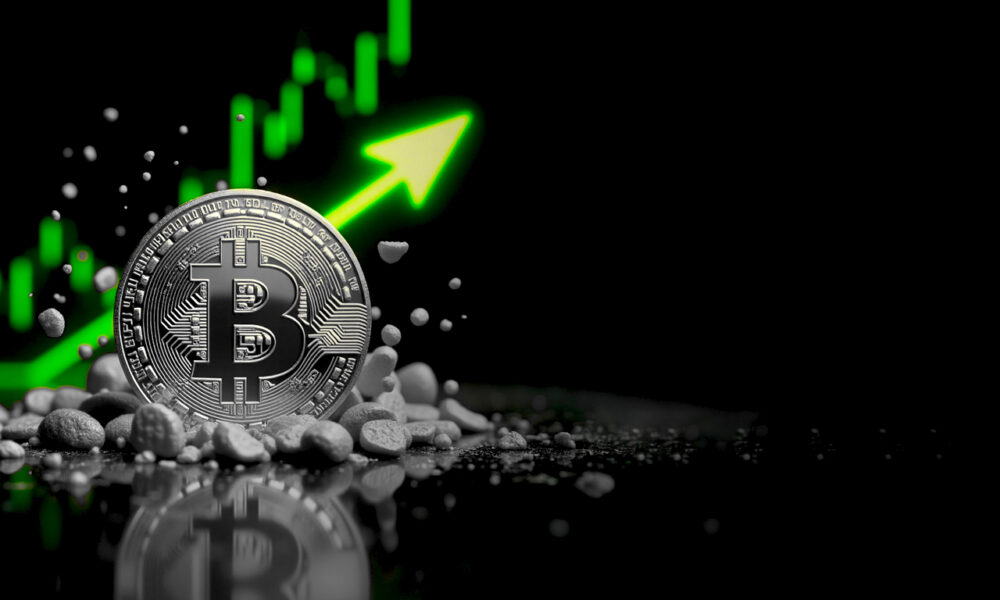 Bitcoin coin with upward trend graph indicating price increase.