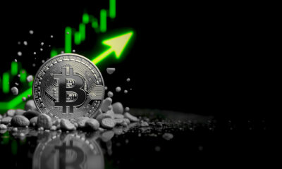 Bitcoin coin with upward trend graph indicating price increase.