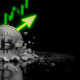 Bitcoin coin with upward trend graph indicating price increase.
